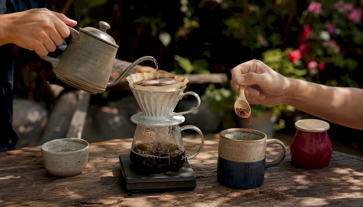 Hands preparing brewed and instant coffee side by side