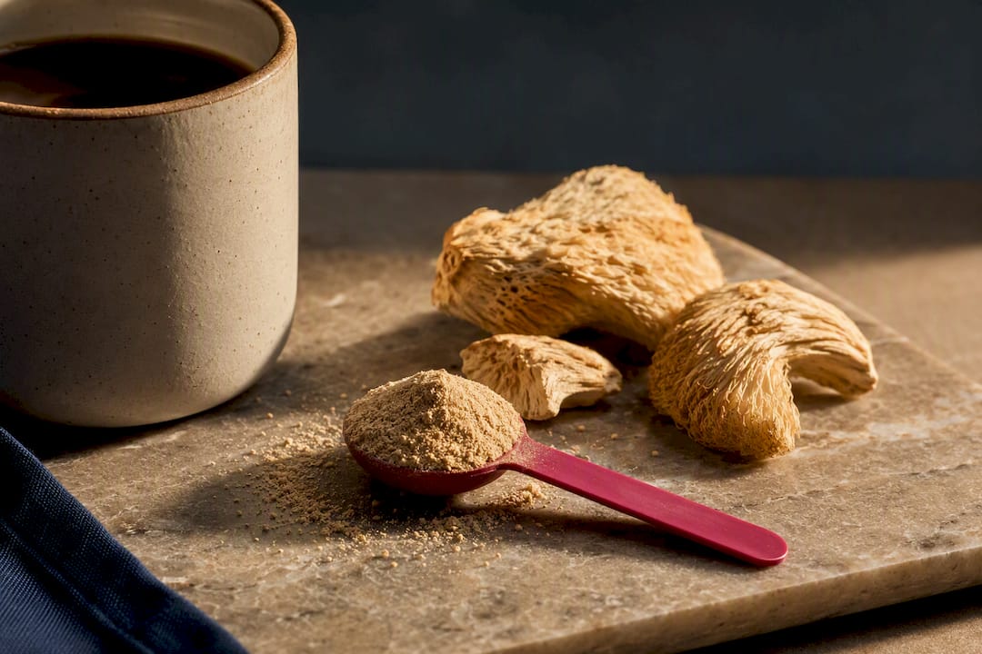 Measured lion's mane powder beside coffee