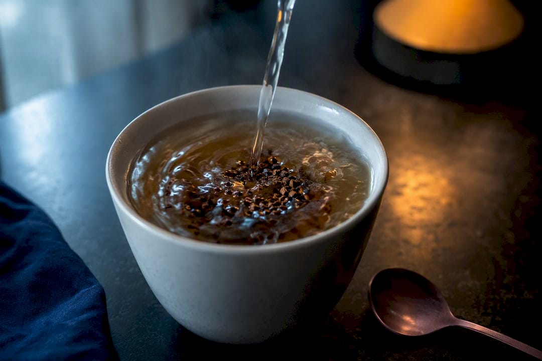 Instant coffee granules dissolving in hot water