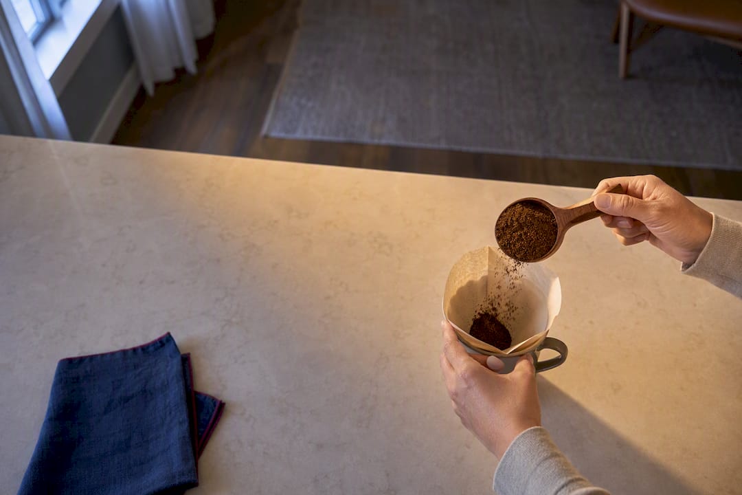 Hands preparing gently brewed coffee at home