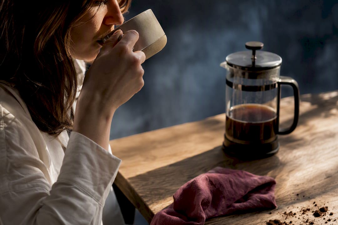 Hesitant drinker tasting mushroom coffee