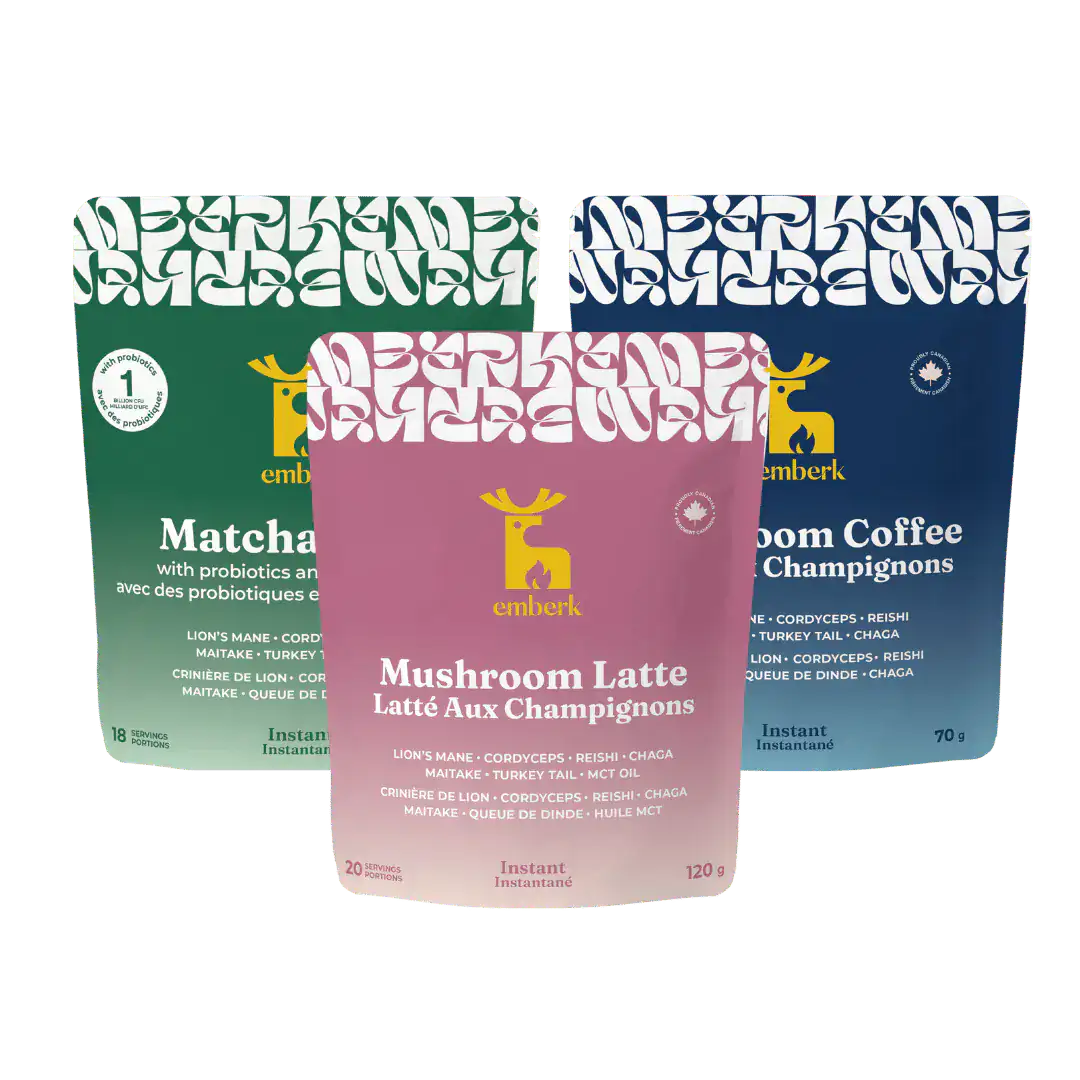Three pouches arranged together: Matcha Latte with probiotics, Mushroom Latte, and Mushroom Coffee. The front pouch is pink and labeled Mushroom Latte, with a deer logo, while the rear pouches are green and blue.