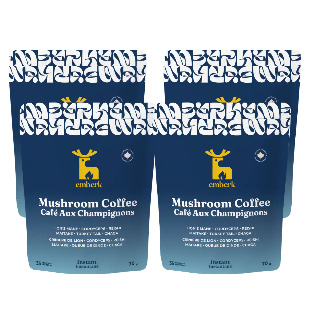 Four blue Emberk Mushroom Coffee stand-up pouches with white and yellow graphics, shown side by side on a white background.