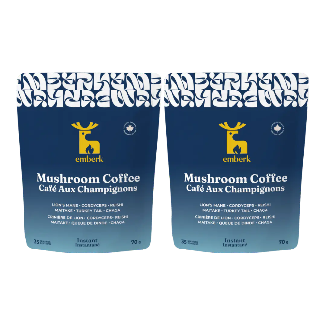Two identical Emberk Mushroom Coffee pouches shown side by side on a plain white background. The packaging is dark blue with a yellow deer logo and white text.