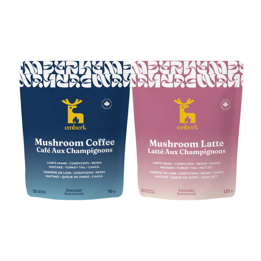 Two stand-up pouches of Emberk mushroom coffee blends on a plain white background: a dark blue pouch labeled Mushroom Coffee and a dusty pink pouch labeled Mushroom Latte. Both packages show the yellow Emberk deer logo and product text.