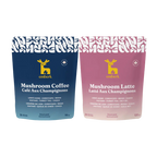 Two stand-up pouches of Emberk mushroom coffee blends on a plain white background: a dark blue pouch labeled Mushroom Coffee and a dusty pink pouch labeled Mushroom Latte. Both packages show the yellow Emberk deer logo and product text.