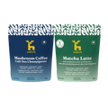 Two Emberk pouches side by side on a white background. The left pouch is dark blue and labeled Mushroom Coffee and the right one is green labeled Matcha Latte