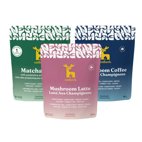 Three pouches arranged together: Matcha Latte with probiotics, Mushroom Latte, and Mushroom Coffee. The front pouch is pink and labeled Mushroom Latte, with a deer logo, while the rear pouches are green and blue.